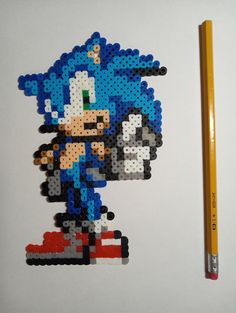 an image of a pixelated sonic the hedgehog character with a pencil and ruler