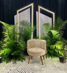 a chair sitting in front of two mirrors with plants around it on either side of the room