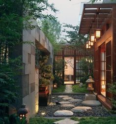 an outdoor garden with stepping stones and lights