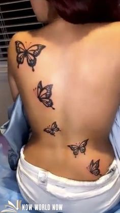 the back of a woman's body with butterflies on her upper and lower back