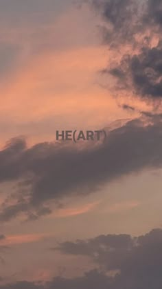 an airplane is flying in the sky with clouds behind it that says heart on top