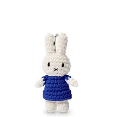 a small crocheted white rabbit wearing a blue dress and holding a keychain