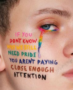 a young man has his face painted with the words if you don't know what we still need pride, you aren't paying close enough attention