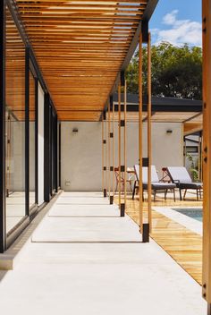 an outdoor covered patio with chairs and tables