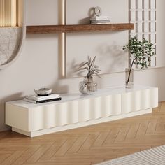 a living room with white furniture and wood flooring on the wooden floor, along with a plant in a glass vase