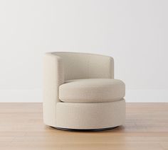 a white chair sitting on top of a hard wood floor next to a white wall