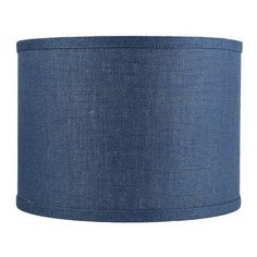 a blue lampshade on a white background with the bottom half covered in fabric