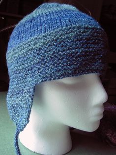 a knitted blue hat on top of a mannequin head