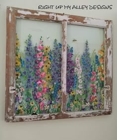 an old window with flowers painted on the glass and some words above it that say right up my alley designs