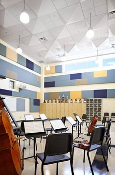 an empty classroom with desks and musical instruments