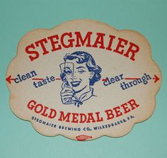 a sign that says steemaler gold medal beer with a woman talking on the phone