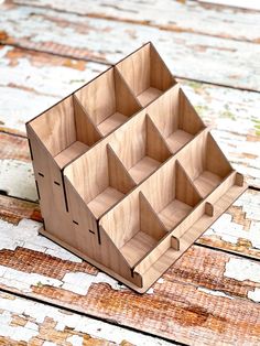 a wooden box with compartments on top of it