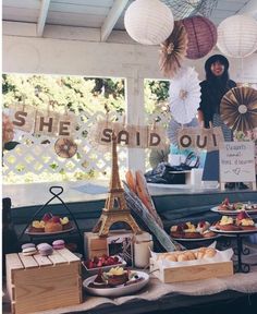 a table topped with lots of pastries and desserts next to a sign that says she said out