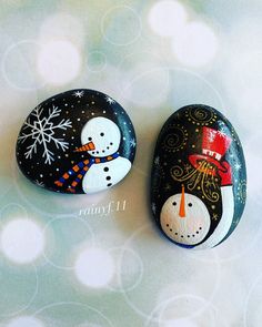 two painted rocks with snowmen on them