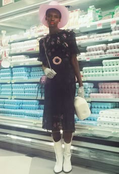 a woman standing in front of a store display