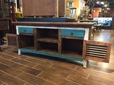 an old blue and white cabinet with drawers on it's sides in a store