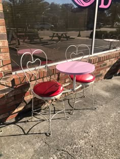 two tables and chairs sitting in front of a window