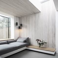 a living room filled with furniture and a window next to a wooden flooring wall