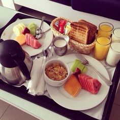 a tray filled with breakfast foods on top of a table