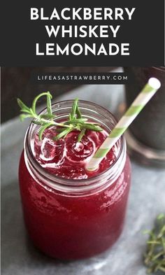 blackberry whiskey lemonade in a mason jar with a straw and garnish on the rim