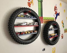 two wall shelves with cars and trucks on them in a child's room decorated with cartoon characters