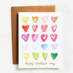 a valentine's day card with watercolor hearts on the front, and an envelope that says happy valentine's day