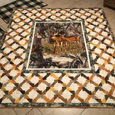 two deer standing in the middle of a patchwork table topper on a tile floor