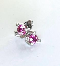 Stunning vintage platinum trillion cut 1.5 ctw natural pink sapphire diamond accent stud earrings. This unique setting features round prongs that create a bezel setting for 6 sparkly diamonds, while also holding the pink sapphires.  The push backs are made of 18k white gold. Setting measures 7mm wide 6.5mm tall 5.3mm depth. The set weighs 3.08 grams. The sapphires measure 6.2mm x 5.8mm, approximate total carat weight 1.5. The color of these stones is beautiful jewel tone pink with blue tones so amazing with great clarity and sparkle even prettier in person. These are a perfect comfortable everyday go to earring with an upscale look. I've had these looked at by my jeweler to verify (he did say it is normal practice to pair the white gold backs with platinum settings). This pair of earrings Mini Vase, Earrings Pink, Blue Tones, Jewel Tones, Sapphire Diamond, Pink Sapphire, Bezel Setting, Jewelry Earrings Studs, Vintage Earrings