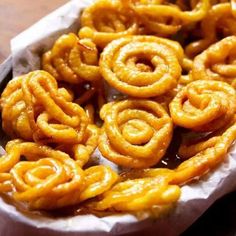 some onion rings are in a basket on a table