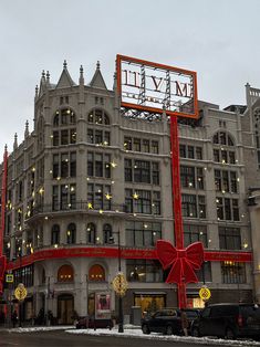 a large building that has a giant red bow on it's front and side