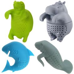 four different colored animal shaped graters with holes in them and one has a fish on it's back