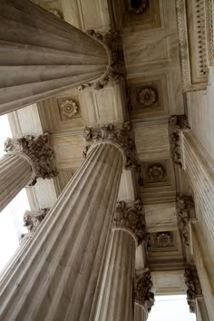 looking up at the ceiling and columns in an old building