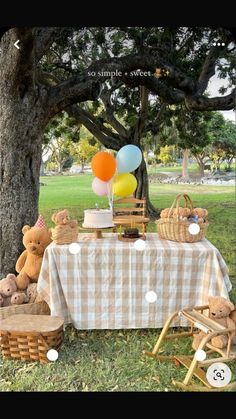 a picnic table with balloons and teddy bears