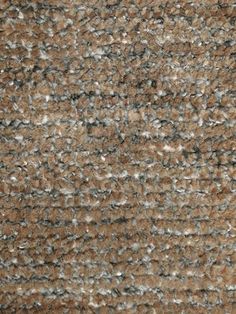 an area rug that is brown and gray with small white dots on the top of it