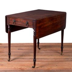 an old wooden desk sitting on top of a wooden floor