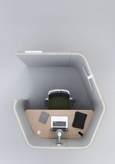 an overhead view of a desk with a computer and other items on it, in the shape of a hexagonal structure