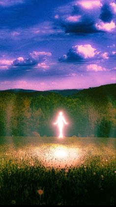 a person standing in the middle of a field under a purple sky with white clouds