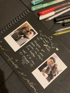 an open notebook with photos and writing on it next to markers, pens and crayons