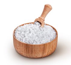 a wooden bowl filled with sea salt