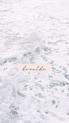 the word breathe is written on a piece of paper in the ocean foamy water