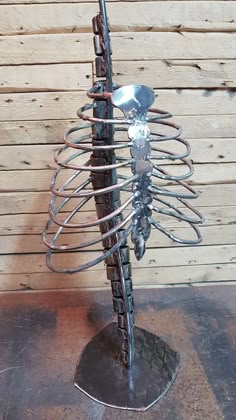 a metal sculpture with a skeleton on it's back