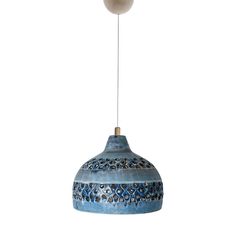 a blue and white hanging light with a wooden ball on it's end, against a white background