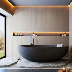 a large black bath tub sitting next to a window