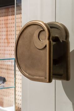 an old fashioned toilet paper dispenser hanging on a wall in a bathroom