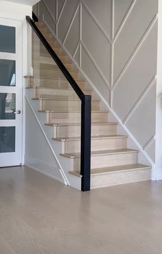 an empty room with stairs leading up to the door