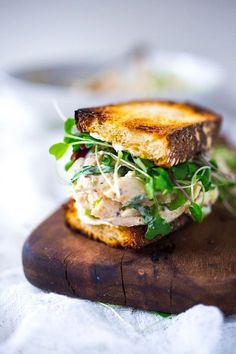 a close up of a sandwich on a cutting board