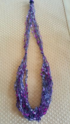 This lightweight adjustable crochet necklace is made from specialty yarn that gives a beaded effect.  There is one  decorative bead that makes the necklace adjustable.  It can go from full length necklace to a choker.  The light and airy crochet necklace is perfect for any season. *measurements:  30 inches *material:  nylon with a hint of lurex *color:  purple, lavender, and silver *free shipping Contact me if you have additional questions. Adjustable Crochet Necklaces For The Beach, Adjustable Crochet Necklace For Beach, Crochet Necklaces For Beach, Crochet Beach Necklaces, Adjustable Crochet Beaded Necklace For Gift, Handmade Purple Lariat Necklace, Adjustable Crochet Necklaces With Round Beads, Adjustable Crochet Necklace For Gifts, Yarn Necklace