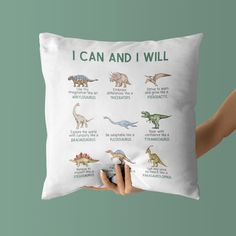 a person holding a pillow with dinosaurs on it that says i can and i will