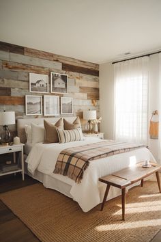 a bed sitting in a bedroom next to a window with pictures on the wall above it