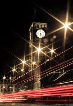 the big ben clock tower towering over the city of london at night with long exposure